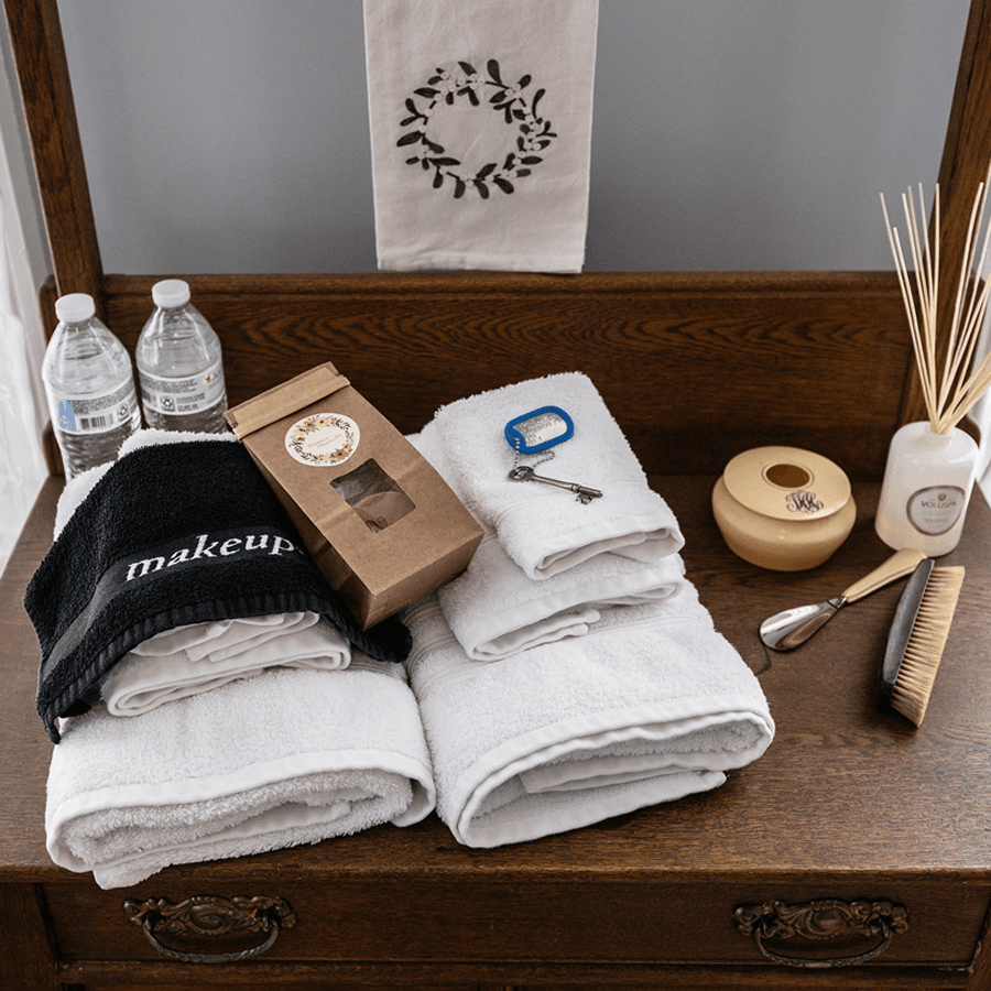Fresh towels and shampoo and soap amenities on bathroom counter