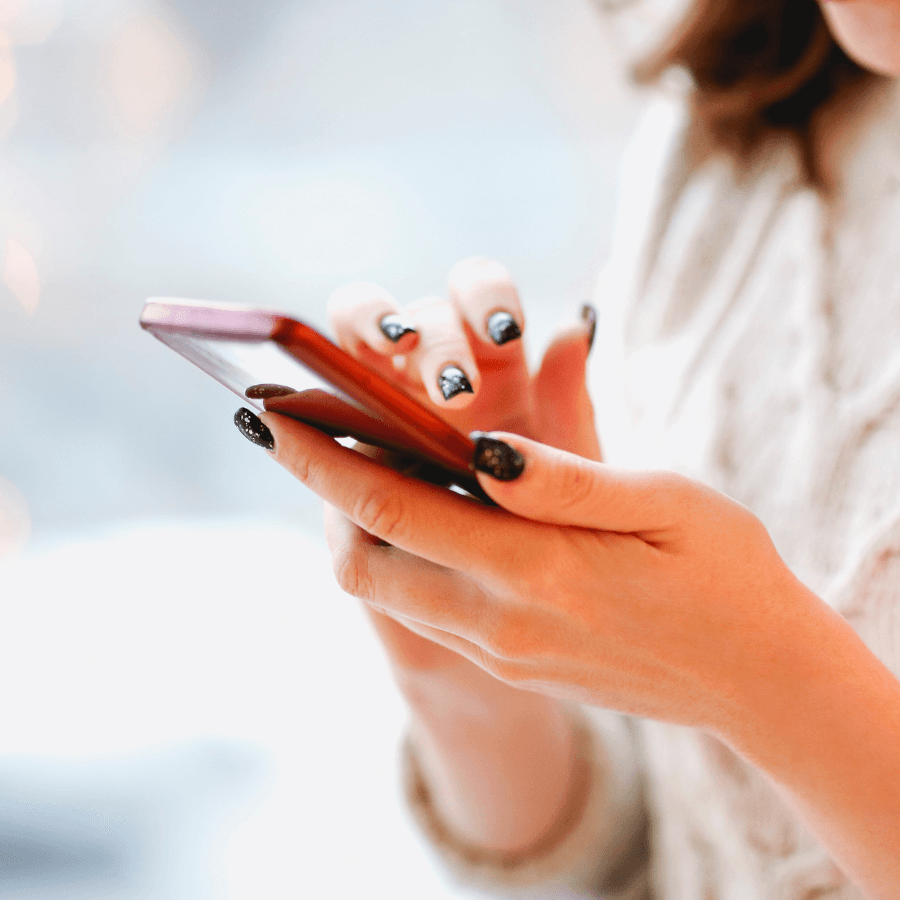 Woman in white shirt using cellphone