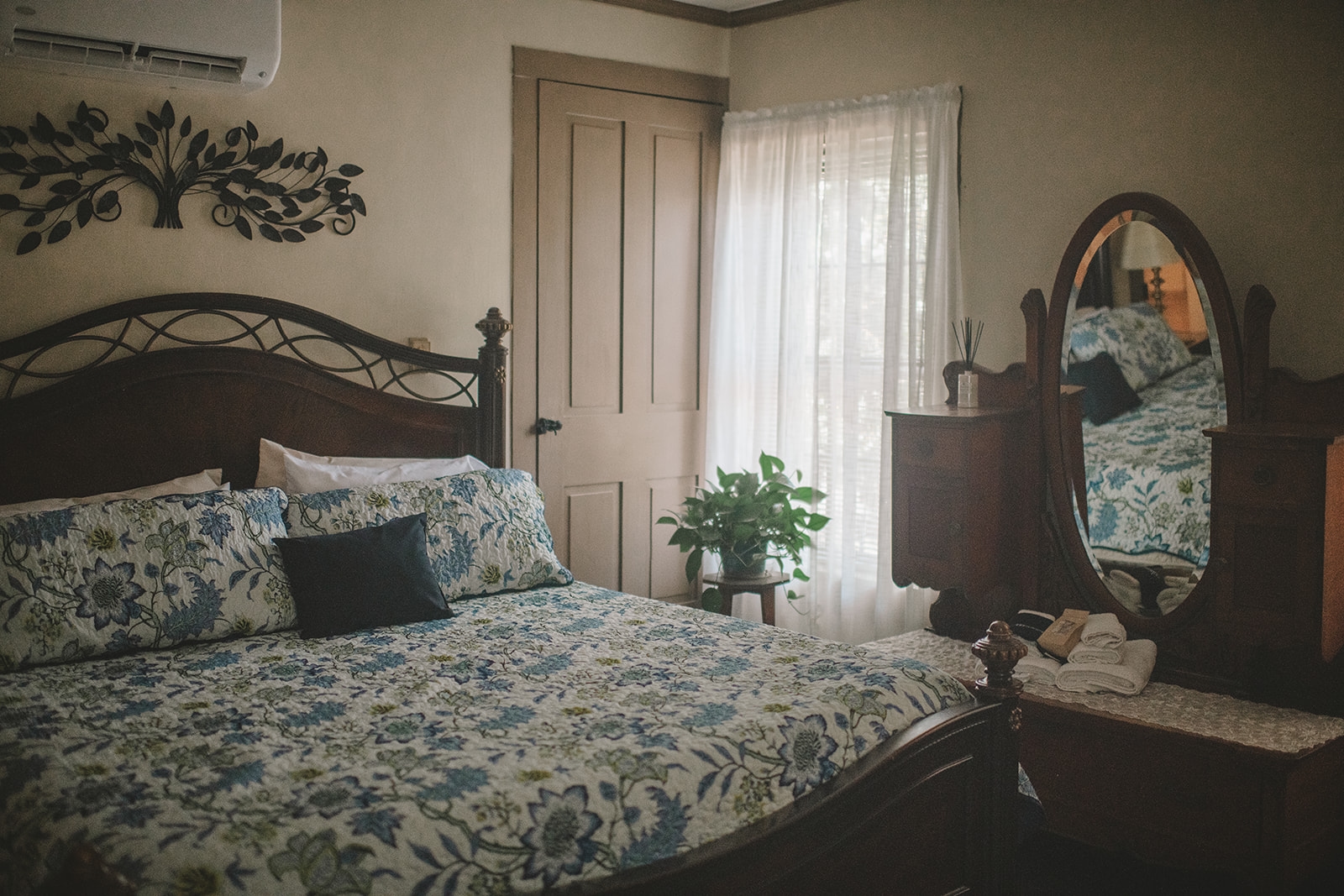 King bed with blue & white patterned comforter