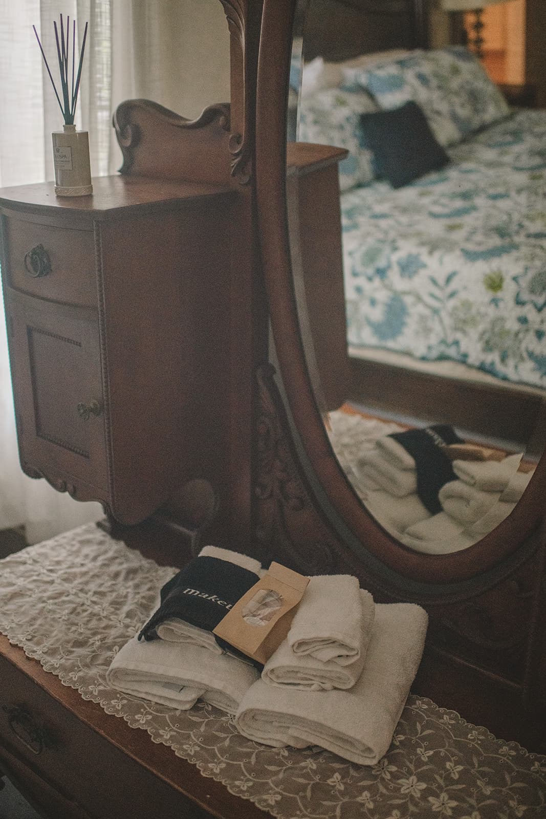 Antique mirror and dresser with two towels